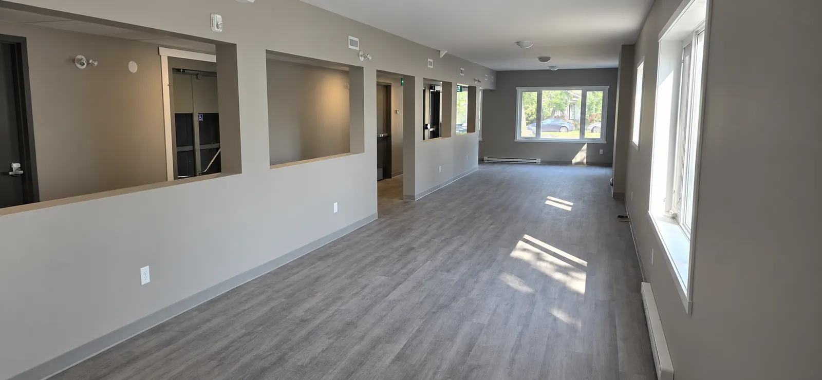 Commercial common space with new flooring, paint and interior windows