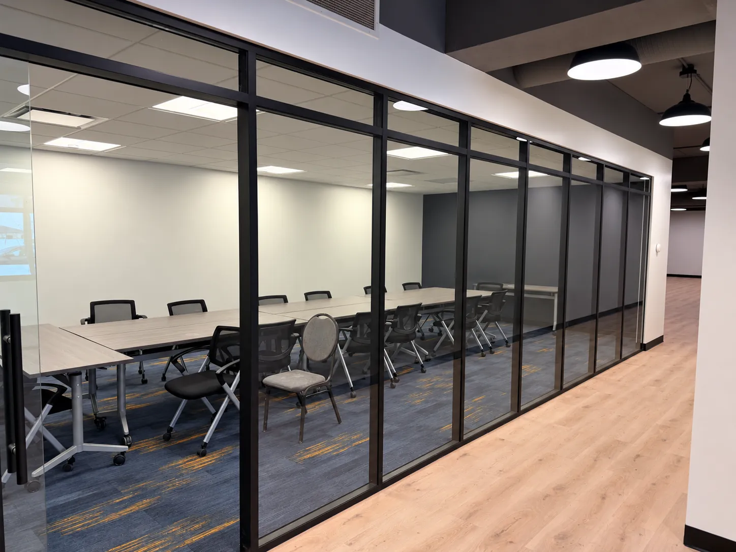 Renovated office with glass meeting room walls and new flooring