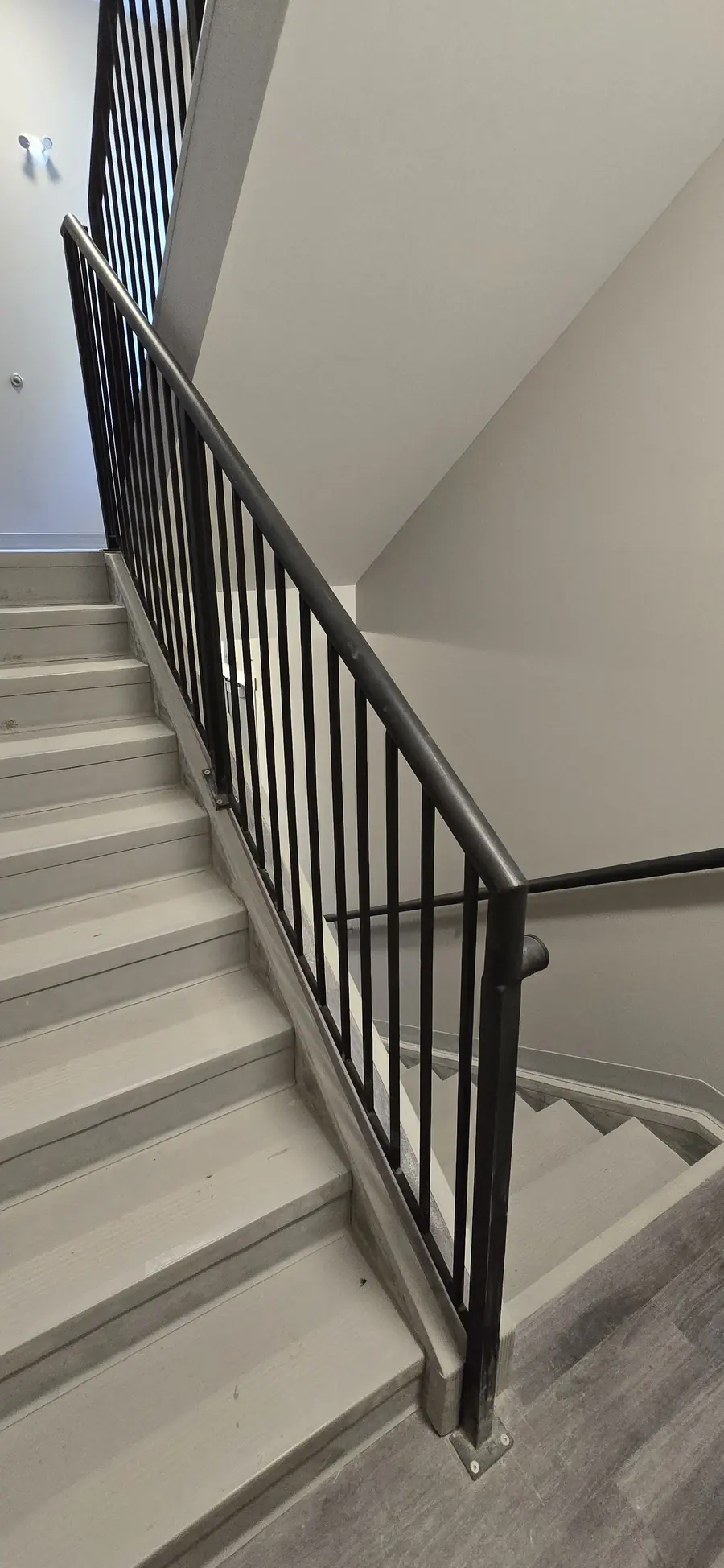 Finished stairwell with metal railing